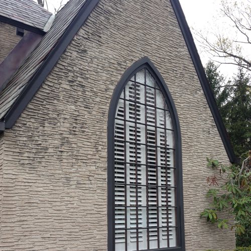 Exterior view of brick home with plantation shutters